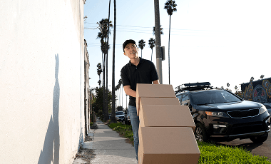 delivery-person-getting-parcel-out-delivery 1