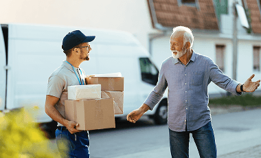 happy-senior-man-welcoming-courier-who-is-delivering-him-packages-home 1 (1)